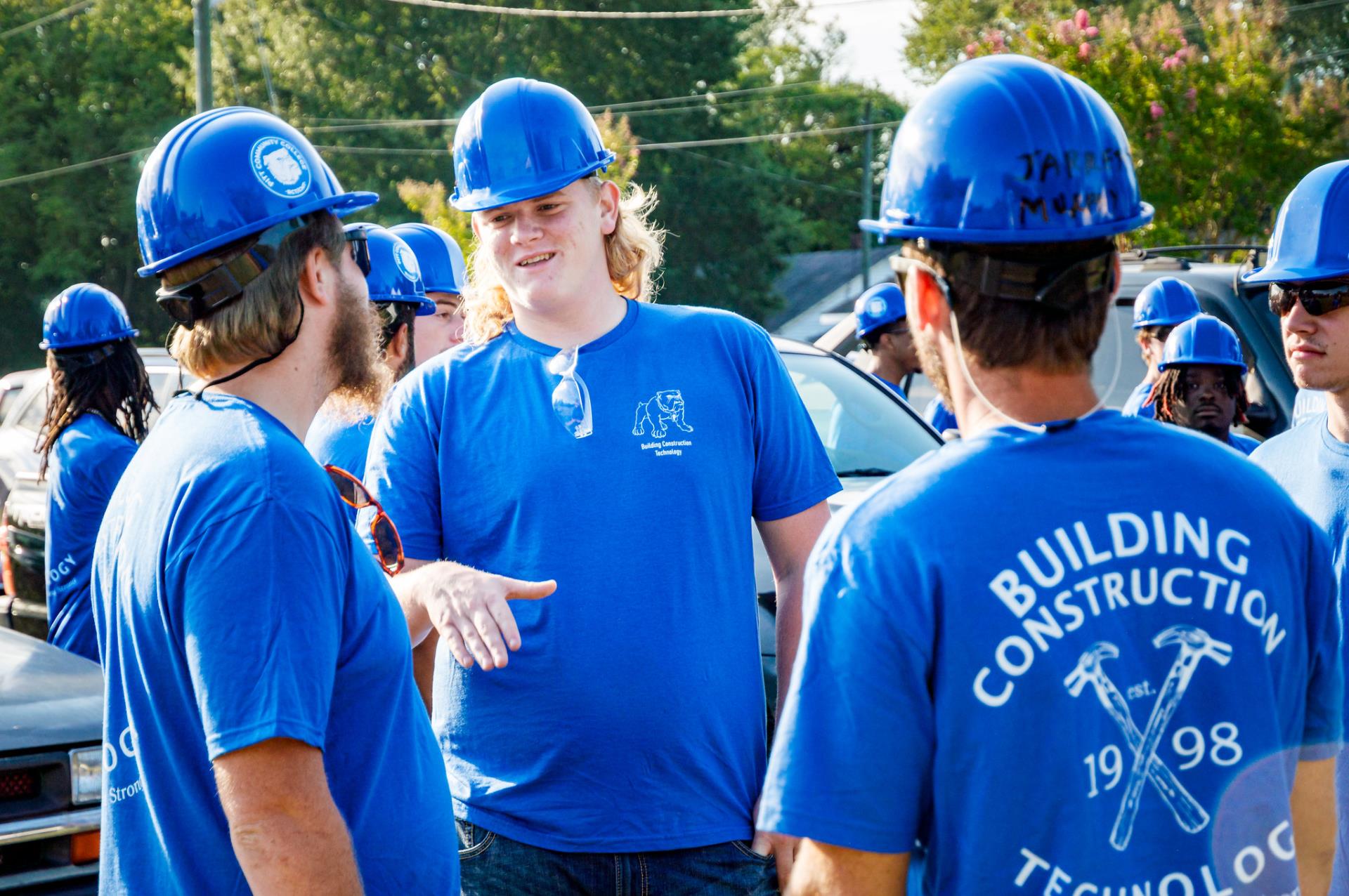 A group of PCC construction students talking.