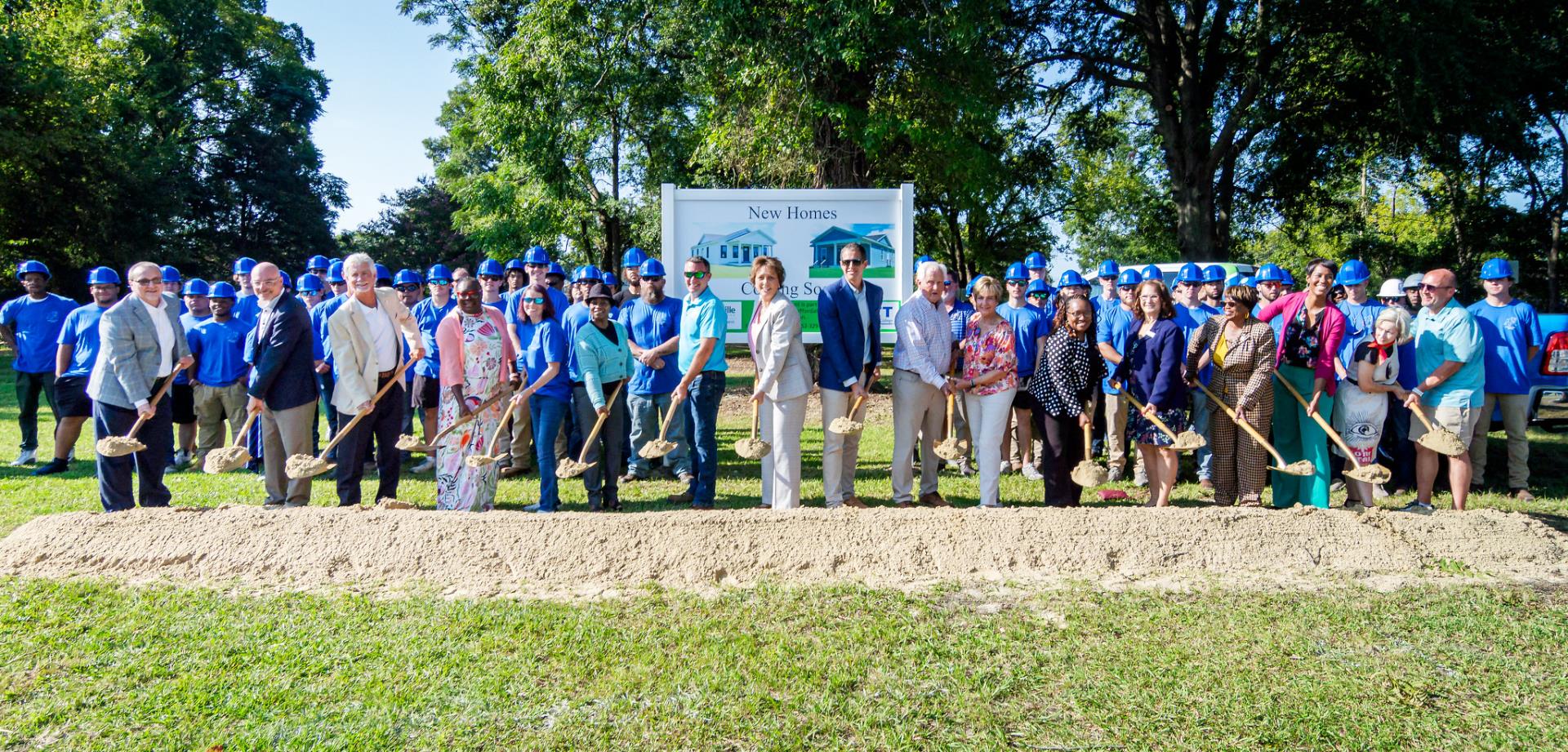 Group of dignitaries holding shovels at the groundbreaking site for the 50 in 10 affordable housing initiative
