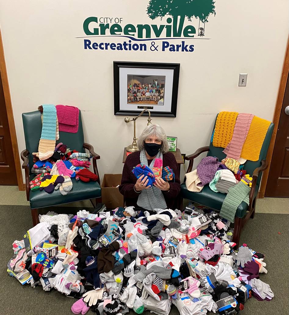 Rendy Bertrand of Recreation and Parks with a large collection of socks and gloves