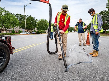 Crack sealing a road