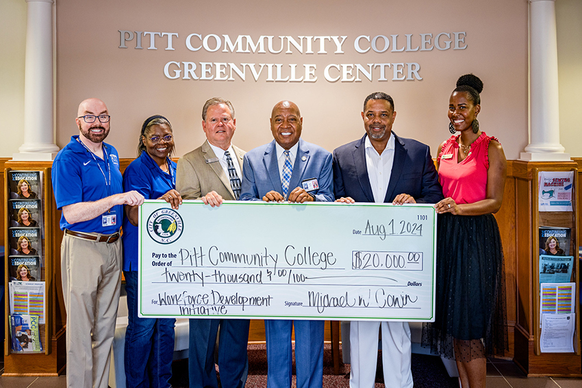 City and PCC officials with a check