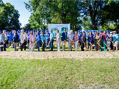 50 in 10 Groundbreaking group with shovels and dirt