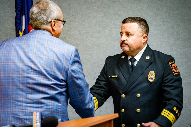 Chief Anderson shaking hands with City Manager