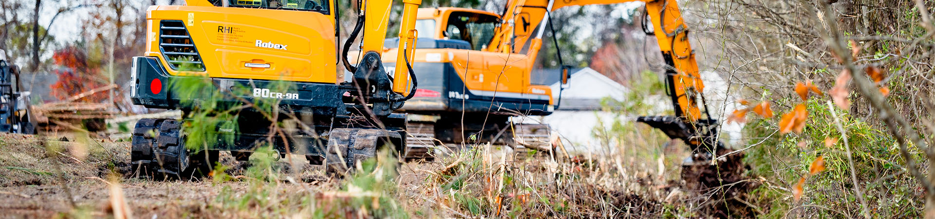 backhoe digging in ditch